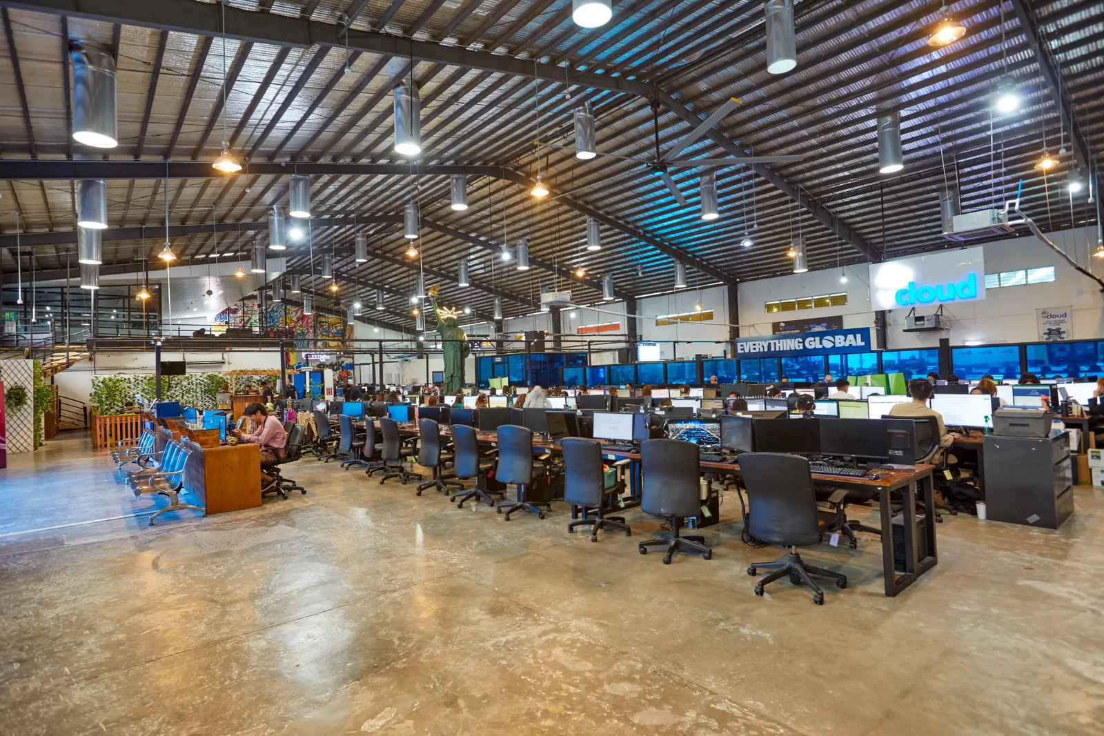 Wide view of the Clark, Philippines office with shared workstations and collaboration areas