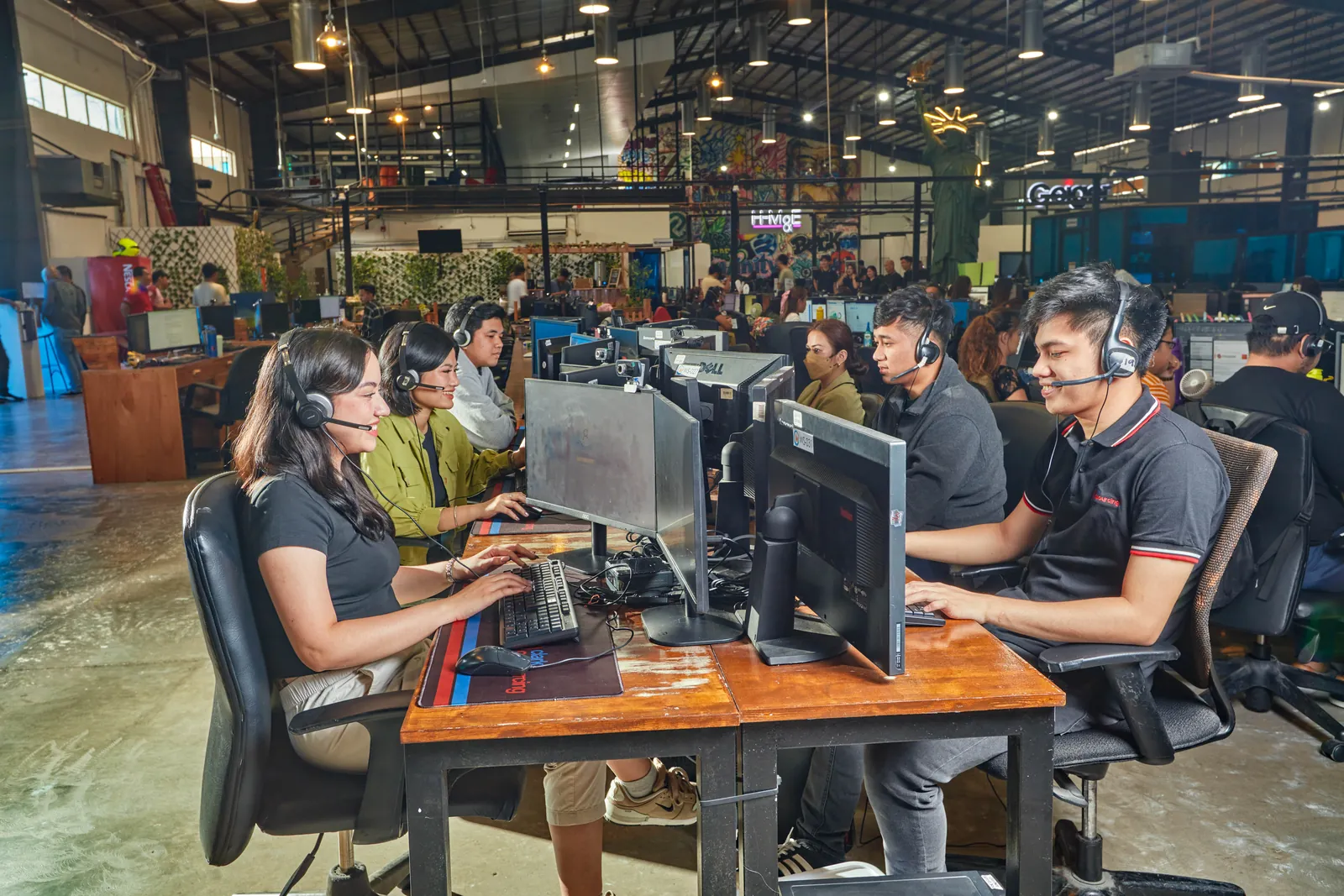 Team members at computer workstations in the Clark, Philippines outsourcing office