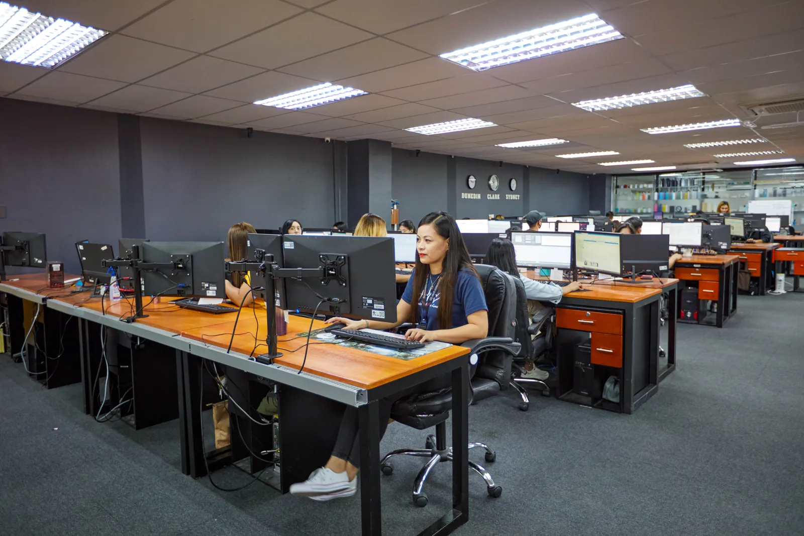 Staff working at individual computer stations in our Philippines office