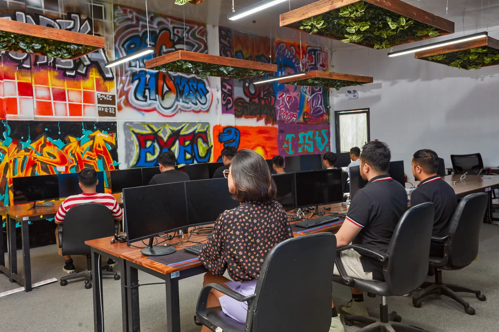 Colleagues working side by side at desktop computers in our Clark office in the Philippines